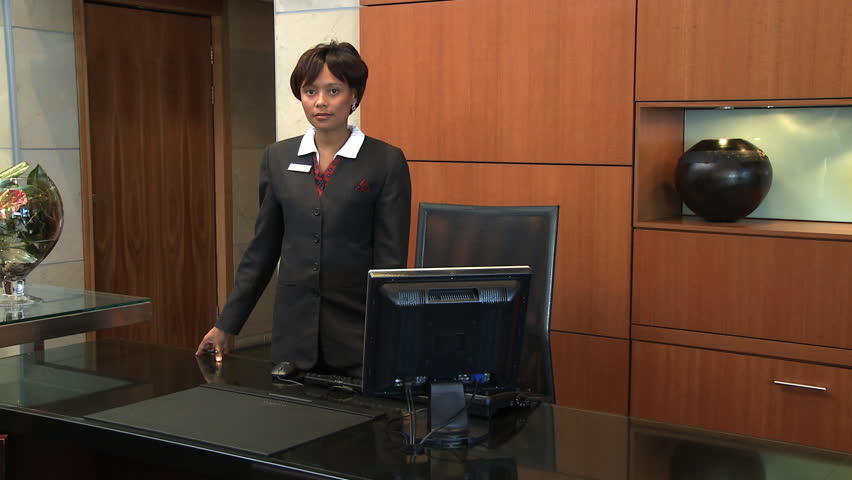 MEDIUM SHOT PAN OF A RECEPTIONIST