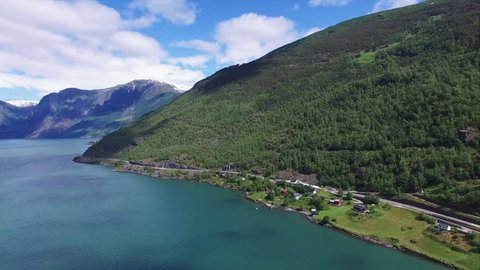 Aerial scenic view of fjord Aurlandsfjorden in Norway with tall mountains surrounding the water.