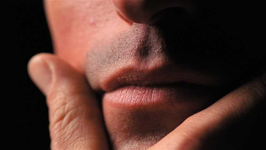 Closeup of man stroking chin