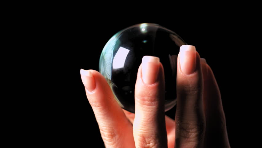 Female hand holds crystal orb