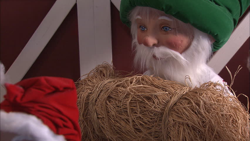 Christmas puppet holding bushel of hay