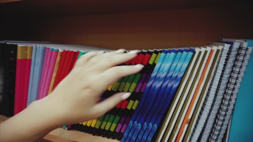 Woman hand choosing notebook in the stationery shop 4K