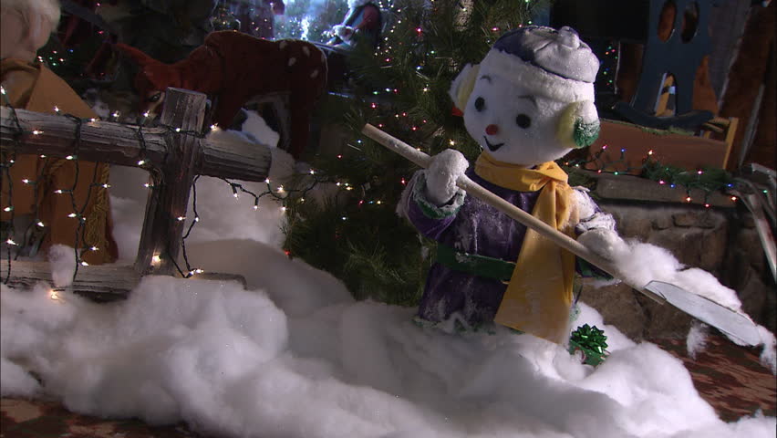 Snowman puppet shoveling snow