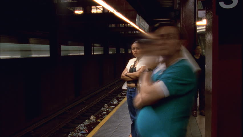 NEW YORK - CIRCA 2003: Unidentified people wait for in the New York City Subway