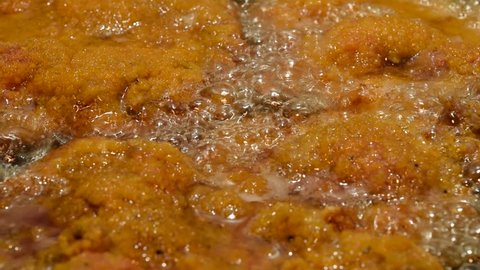 Traditional Austrian wiener schnitzel in hot oil