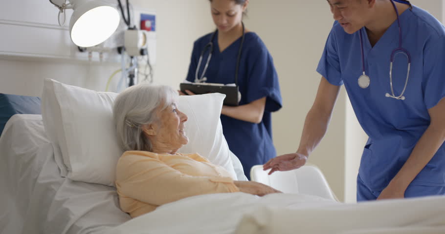 4K Caring medical workers in hospital talking to elderly lady at her bedside (UK-Oct 2016) | Shutterstock HD Video #21577168