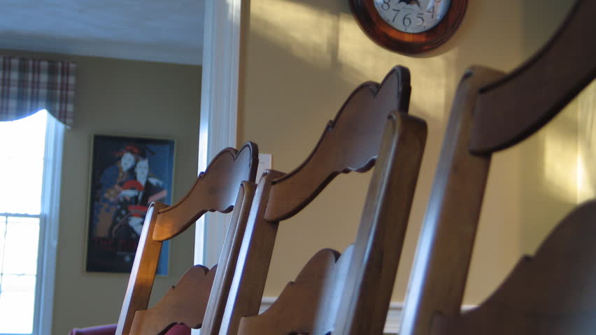 Time lapse of sunlight moving over dining room chairs