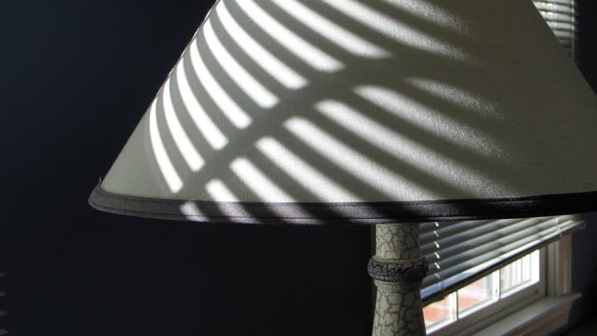 Time lapse of sunlight moving over lamp shade