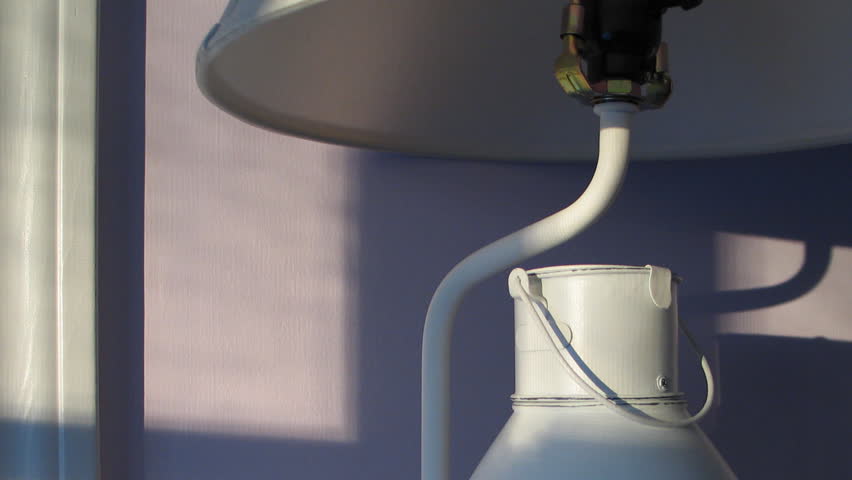 Time lapse of sunlight moving over lamp