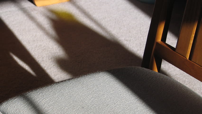 Time lapse of sunlight moving over chair
