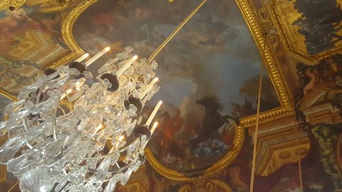 Versailles Mirror Room. Tilt down from a chandelier in the hall of mirrors central gallery at France's famous Palace of Versailles. 2016