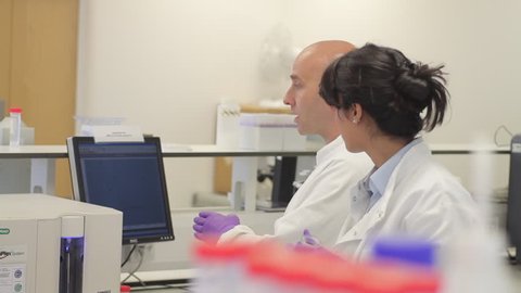 Scientist looking at liquid in laboratory