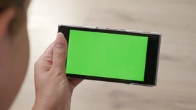 Close-up of woman and greenscreen smart phone in hands 4K 2160p 30fps UltraHD footage -  Green screen tablet display with female at home 3840X2160 UHD video