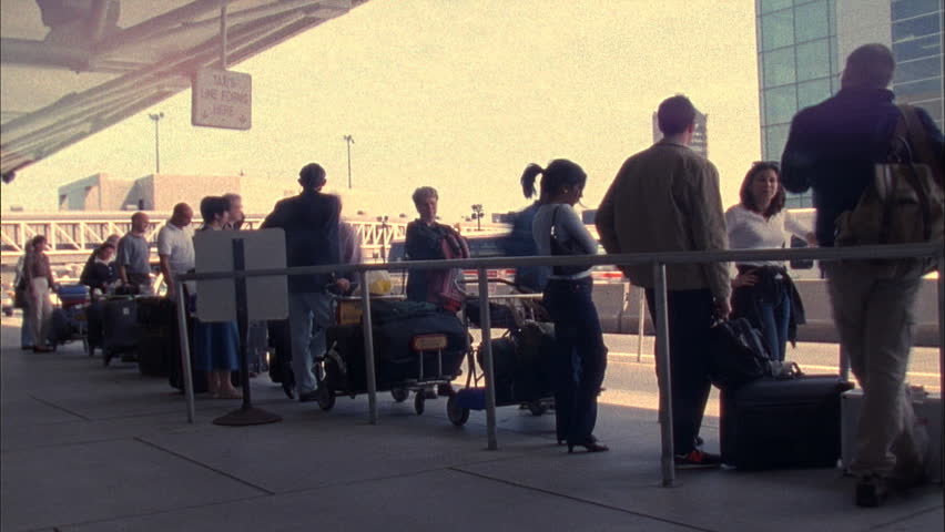 BOSTON - CIRCA 2001: Unidentified travelers wait at a Taxi stand in Boston's