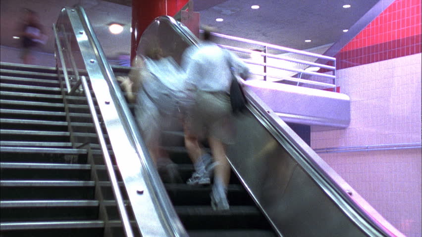 People riding escalators and stairs