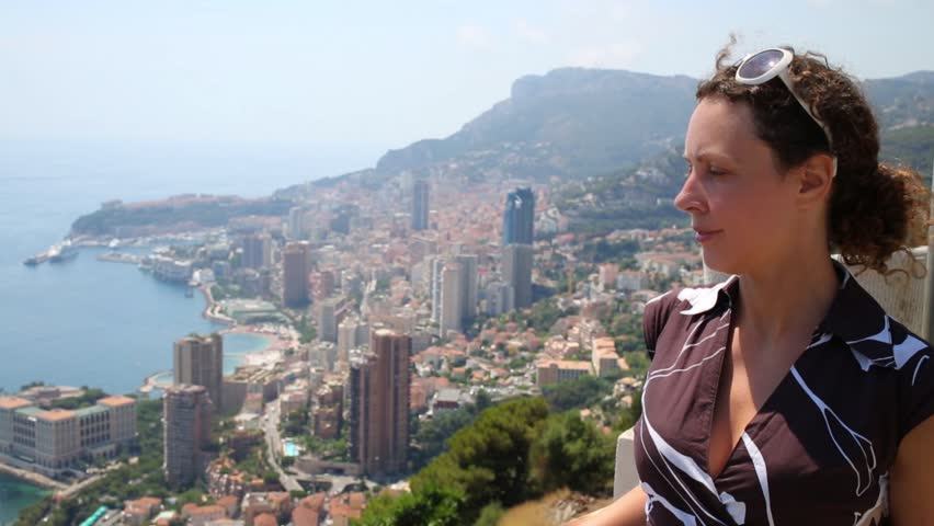 Woman stands on a hill overlooking Monte Carlo, Monaco