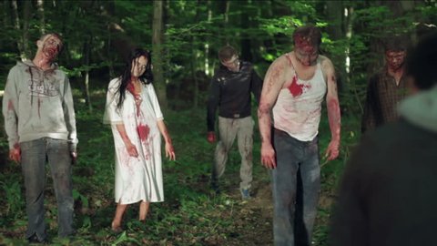 Zombies eat a man in the forest. HD