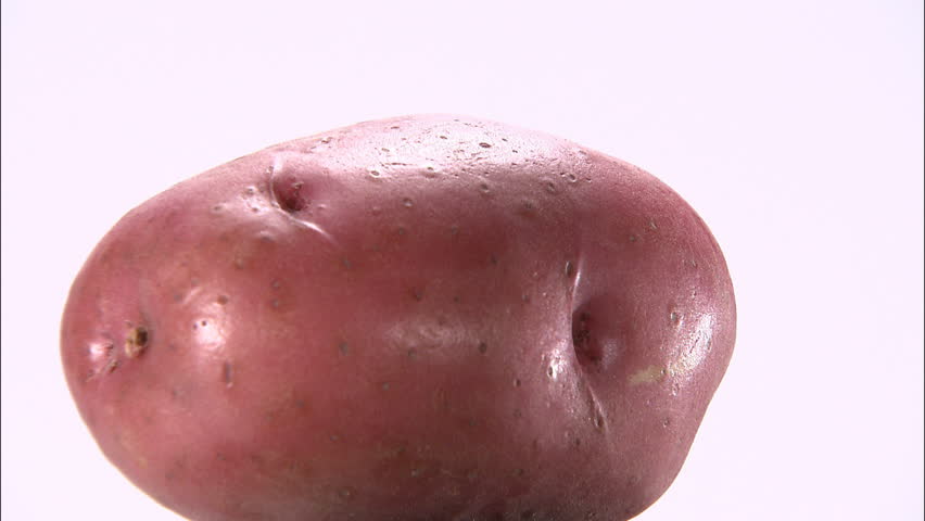 Rotating red skinned potato