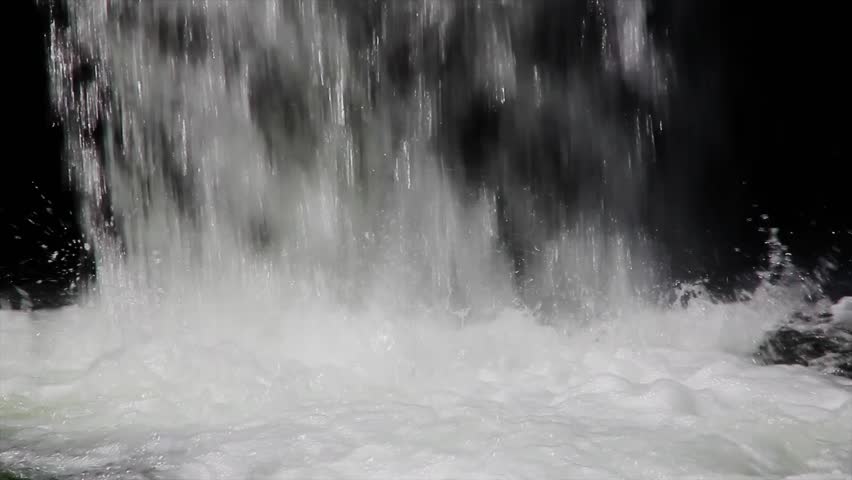 A waterfall pouring into a river