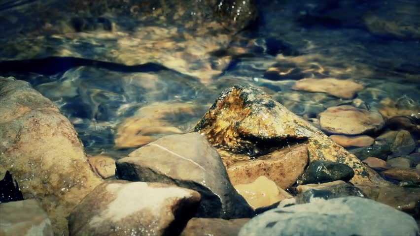 Water on the shore of a beautiful mountain river