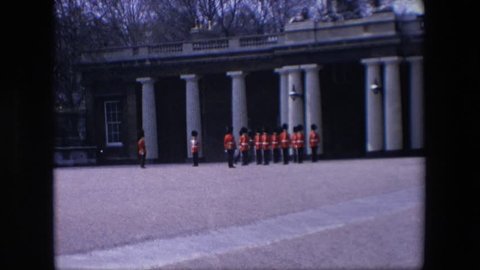 LONDON ENGLAND 1967: beefeater soldiers marching and standing in formation in front of building with white columns