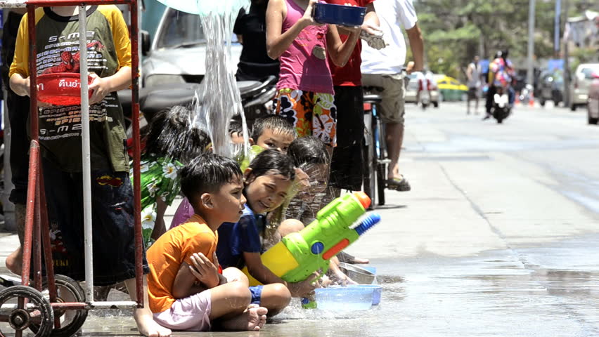 BANGKOK - APRIL 13: Children getting showered with water, during the annual