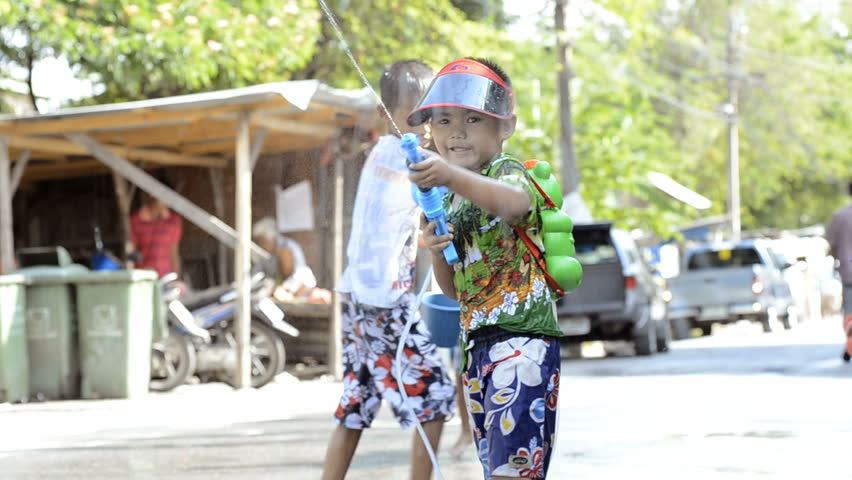 BANGKOK - APRIL 13: Young boy showing off his water pistol during Songkran