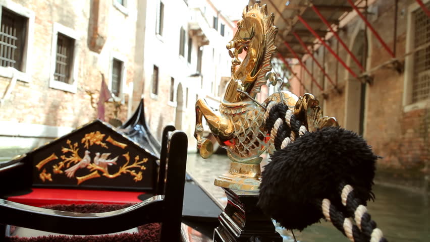 Gondola Ride Venice Part One (HD). Gondola ride in Venice Italy with focus close up on the golden horse. All background is blurred out with fast lens.