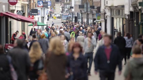 Defocussed shot of anonymous people walking on UK high street