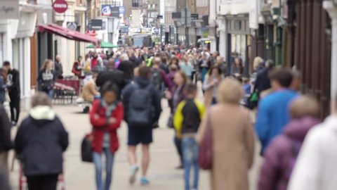 A defocussed shot of anonymous people walking on a busy British high street