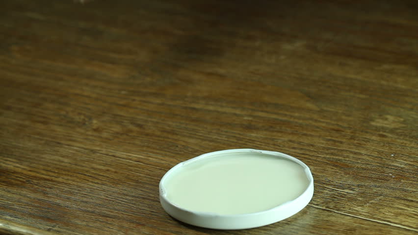 puppy drinking milk from a saucer