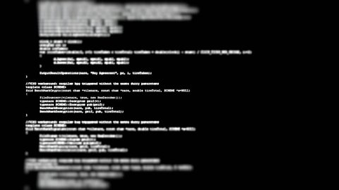 Showing a flow of source code text (instructions for a computer program) on a PC screen in tilt-shift. White characters, black background.
