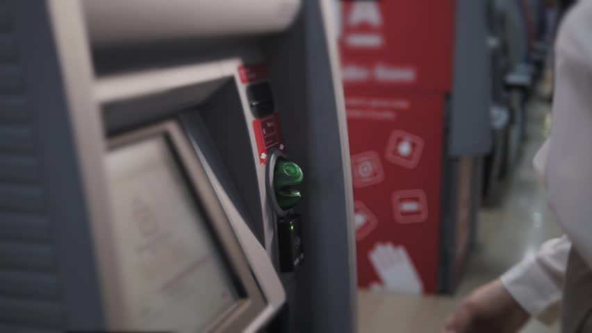 young woman inserting a credit card to ATM, beautiful girl banking