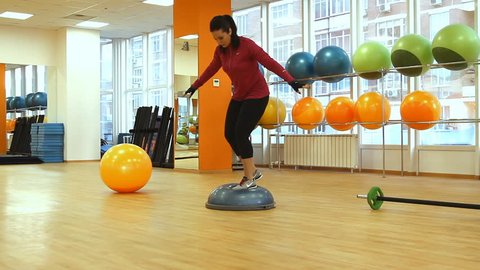 Rostov on Don, Russian Federation – January 05, 2014: Young woman doing fitness exercise with bosu ball.