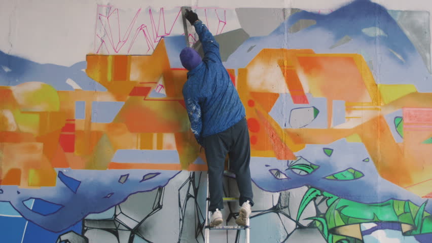Graffiti artist painting on the wall, exterior Royalty-Free Stock Footage #21661120