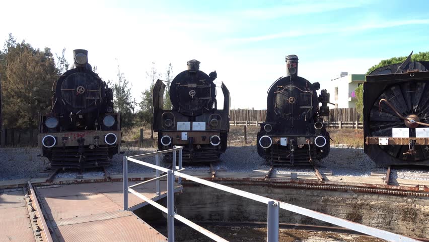 Selcuk, Turkey - 26th of October, 2016:  4K At the Selcuk locomotive museum - Panning exposition of old steam locomotives, a child in one of them
