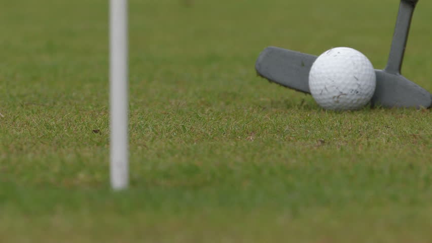 Golf - hitting ball into cup 