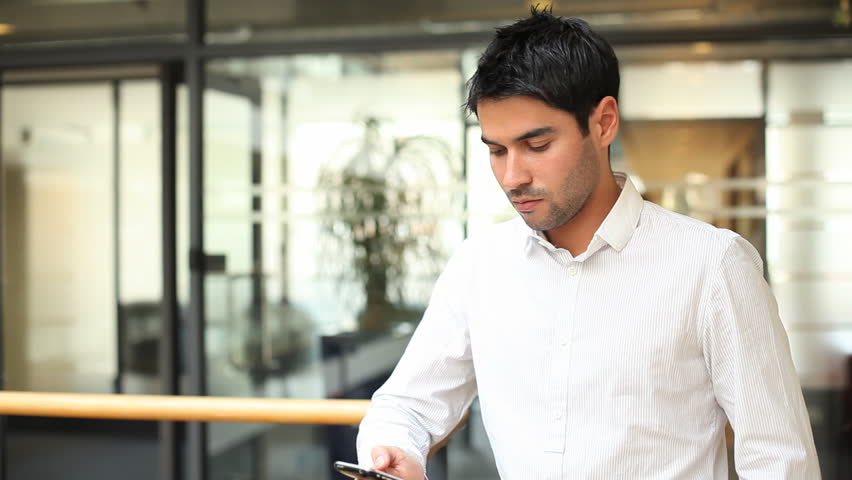 Business male answering phone call in office building