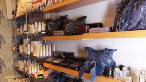 MEDIUM SHOT, Females looking in shop at handbags
