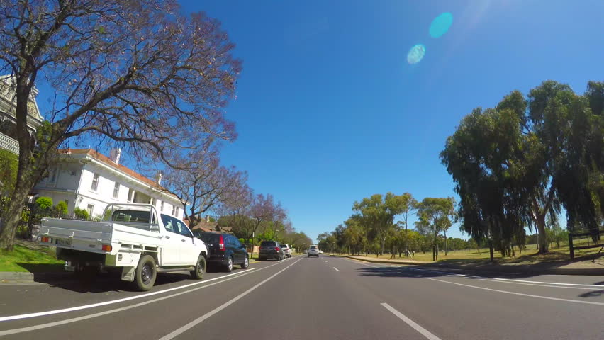North Adelaide, South Australia vehicle POV, driving along LeFevre Terrace with luxury homes and parklands to the side. 