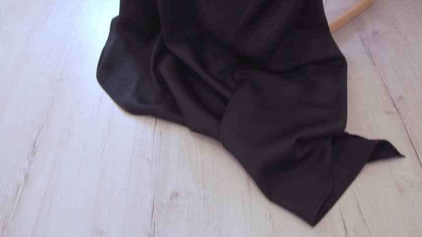 Fashion video of young beautiful woman in black long dress sitting in armchair