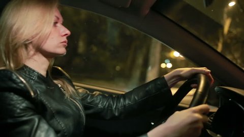 Blondie young woman driving a car