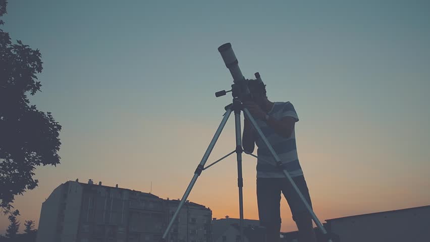 Man looking through a telescope. Royalty-Free Stock Footage #21698629