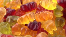 Portion of Gummy Bears rotating on a wooden plate (not loopale; 4K)