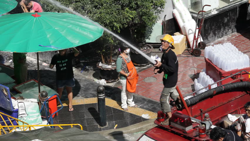 BANGKOK - APRIL 15: A fireman is celebrating Songkran Water Festival at Silom in