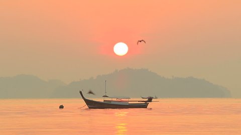 fishery boat floating over sea and sun rising sky background