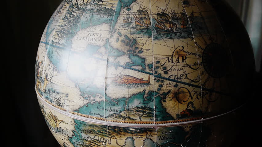 Antique globe with a bar inside of it. A waiter opens the globe and serves a