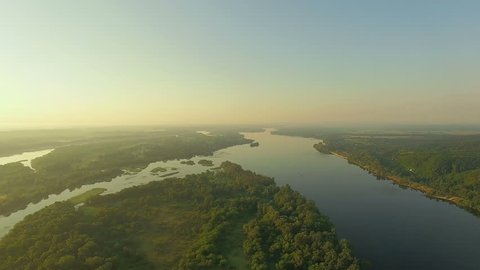 aerial view of river at sunrise 4K, forest and river in morning mist, Very high view of the river forest at sunrise, Aerial view of mystical river at sunrise with fog, sun above the river aerial