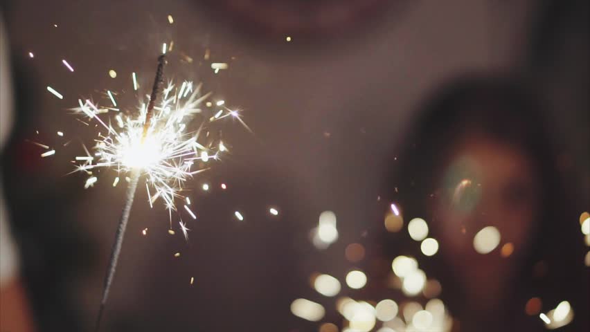 Close up family hands with sparklers lights in christmas eve HD