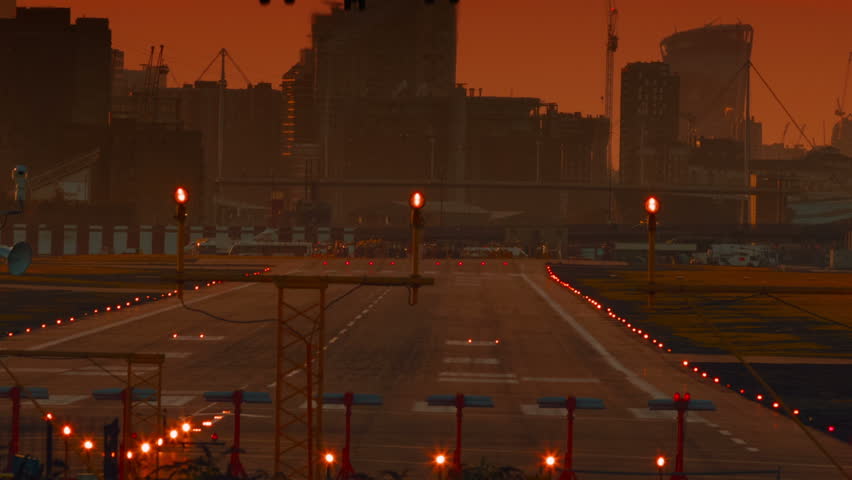 London City Airport - An ultra closeup shot showing the landing moment of a large airliner during sunset. It opened in 1987 serving the twin centers of London financial industry: City and Canary Wharf